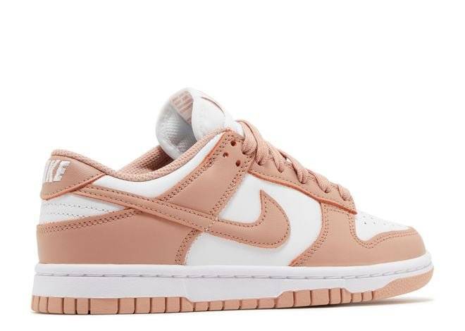 Women's Nike Dunk Low Rose Whisper sneaker showcasing a sleek low-top silhouette with Rose Whisper overlays and white accents.