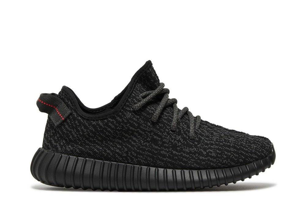 Yeezy Boost 350 Pirate Black 2023 sneaker featuring a black primeknit upper, Boost midsole, and red heel tab. Stylish and comfortable streetwear shoe.