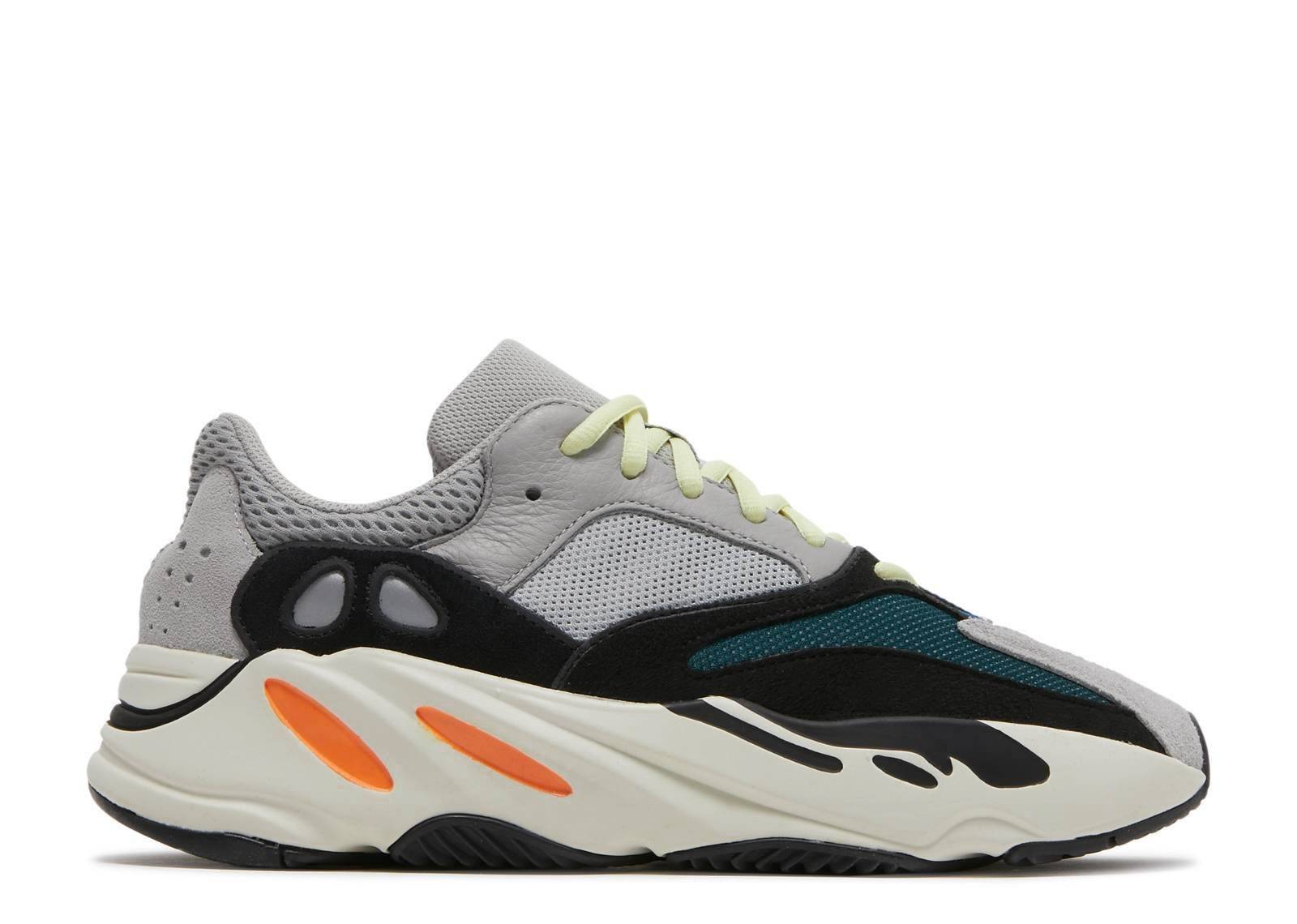 Yeezy Boost 700 Wave Runner 2023 sneaker featuring a grey mesh upper, black suede overlays, and a thick Boost sole with orange accents.