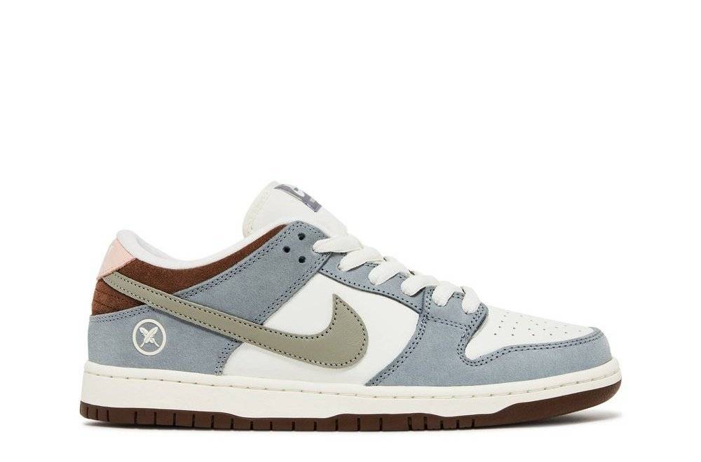 Yuto Horigome x Dunk Low SB sneaker featuring a Wolf Gray and Sail colorway with brown accents, low-top design, and Nike SB branding. Ideal for skateboarding and casual wear.